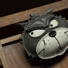 a close up of a cat mask on a wooden surface