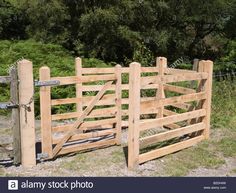 an old wooden gate in the middle of a field