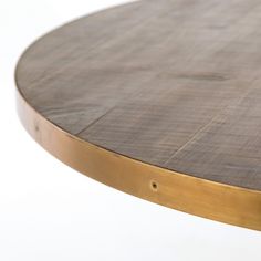 a close up of a wooden table with gold trimmings on the top and bottom