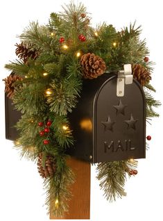 a mailbox decorated with pine cones and lights