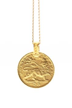 THE HAILE Selassie Coin Necklace is handcrafted from an authentic antique Ethiopian coin. Haile Selassie, born Ras Tafari Makonnen, was Ethiopia's Emperor from 1916 to 1974. He is a member of the Solomonic Dynasty who traced his lineage to Emperor Menelik I. Traditional Medallion Necklace With Coin Pendant, Ancient Style Coin Pendant Medallion Necklace, Ancient Style Coin Pendant Necklace, Classic Engraved Medallion Coin Necklace, Antique Coin Necklaces For Ceremonial Occasions, Antique Coin-shaped Necklaces For Ceremonial Occasions, Traditional Round Coin Necklace, Antique Coin Necklace For Commemoration, Engraved Brass Coin Medallion Necklace