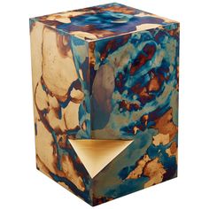 a blue, brown and white marbled cube light fixture with a wooden base on an isolated white background