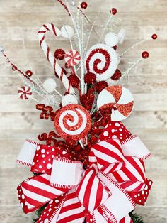 a red and white christmas tree with candy canes