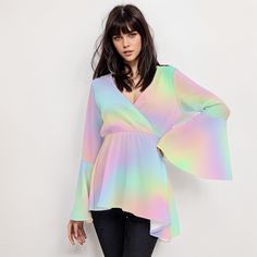 * Elevate your style with our Ombre Rainbow Top, a perfect blend of vintage charm and modern flair for women. * Embrace the 70s vibe with this Boho Top featuring groovy bell sleeves and a high empire waistline. * Made for the free-spirited, this 70s Disco Top boasts a stunning rainbow ombre pattern print. * Crafted with care, this Hippie Top combines comfort and style with its wrap top bodice design. * Stand out from the crowd in this Bohemian Top Women, perfect for adding a pop of color to any outfit. * Whether you're dancing the night away or soaking up the sun, this Ombre Top Women is sure to turn heads. Designed in California by Trendy Hip Buys. Handmade to order from overseas. 100% Polyester ● Fabric: 100% polyester ● Regular fit ● V-neck, Bell Sleeves ● Fabric weight: 80gm ● Care Ins Trendy Long Sleeve Festival Blouse, Trendy Long Sleeve Blouse For Festival, Trendy Spring Festival Blouse, Spring Festival Multicolor Blouse, Multicolor Hippie Blouse For Fall, Flowy Multicolor Party Tops, Fitted Rainbow Top For Spring, Fall Hippie Multicolor Blouse, Retro Rainbow Tops For Spring