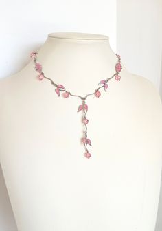 Girlish, romantic, minimal bib necklace, handmade vintage from the '90s. A really charmy, dainty piece of jewelry, light, elegant but eye catching. Silver tone metal garland is combined with light pink glass beads and enamel leefs charms. Short necklace, stands high at the neckline, but continues at a long bib of the same kind. Total length 41.00 with additional expand chain, bib length 8.50 cm. Please remember that it is not a new item, so there can be time signs on it. In perfect condition. Pink Wire Wrapped Necklace, Delicate Pink Choker Necklace, 90s Beaded Necklace, Handmade Adjustable Feminine Necklace, Handmade Adjustable Feminine Necklaces, Minimal Vintage, Valentines Day Presents, Beaded Statement Necklace, Girlfriend Gift