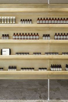 the shelves are filled with different types of essential oils and lotion bottles on them