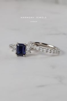 a blue sapphire and diamond ring on a marble surface