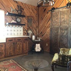 a living room with wooden walls and furniture