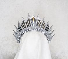 a silver crown on top of a white towel