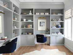 a home office with built - in shelving and desk