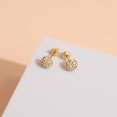 Our enchanting 14k Yellow Gold Children's Earrings are a fun accessory for your little one's delicate ears. Crafted with love and precision, this earring features a round-shaped ball adorned with sparkling clear cubic zirconia stones, adding a touch of glamour to your child's style. The 14k yellow gold construction ensures durability and a timeless elegance that will make your little one shine on any occasion. Safe and comfortable, this charming earring is specially designed for children, making Adjustable Huggie Earrings Fine Jewelry, Adjustable 14k Gold Huggie Earrings, 14k Gold Pierced Cluster Earrings As Gift, Adjustable Yellow Gold Earrings Fine Jewelry, 14k Gold Huggie Birthstone Earrings, 14k Gold Cluster Earrings For Gift, 14k Gold-filled Yellow Gold Earrings, Tiny 14k Gold Drop Earrings, Yellow Gold Huggie Birthstone Earrings