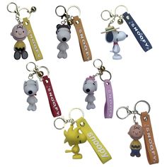 six key chains with cartoon characters on them, all in different colors and sizes are shown