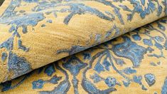 two blue and yellow rugs laying on top of each other