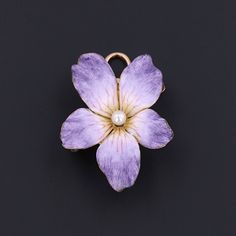 During Victorian and Edwardian times the gift of violets suggested that the giver's thoughts were occupied with love. A perfect love token, this purple enamel brooch/pendant features a lustrous pearl accent at its center. The piece measures 1.1 inches from top to bottom by 0.9 inches wide. The violet is in very good condition; however, the safety catch is a later replacement, as is the ring at the top of the collapsible bail. The brooch bears the maker's mark for Bippart & Co. on the reverse. We Lavender Brooch Jewelry As A Gift, Elegant Flower Enamel Pin Collectible, Victorian Style Enamel Pin Gift, Elegant Yellow Gold Enamel Pin Gift, Purple Brooch Jewelry Gift, Antique Purple Brooches As Gift, Vintage Turquoise Ring, Love Token, Jewelry Post