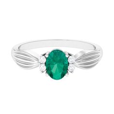 Product Details Amidst gleaming round diamond sits majestically an oval lush green emerald in this solitaire ring that looks splendid with its unrivalled allure. Secured in a prong setting, the emerald and diamond impeccably complement each other in the most eye-catching way. The pinched shank is the perfect classic addition to this dazzling piece. Wear it as stand-alone jewelry to create the maximum effect. Product Information SKU SHP-RINGS0721117454 Width 7 mm Height 3.8 mm Weight 2.24 gm (Approximate) EMERALD INFORMATION No.of Stones 1 Pieces Total Weight 0.72 Carat (Approximate) Dimension(approx) Oval-5X7 mm-1 Pcs Color Green Cut Brilliant Shape Oval Setting Type Accent Quality Grade AAA DIAMOND INFORMATION No.of Stones 4 Pieces Total Weight 0.14 Carat (Approximate) Dimension(approx) R Emerald Solitaire Engagement Ring, Ring With Diamond, 18k Yellow Gold Ring, Green Emerald, Lush Green, Solitaire Engagement, Solitaire Engagement Ring, Yellow Gold Rings, Solitaire Ring