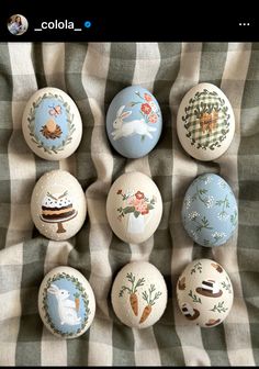 several decorated eggs sitting on top of a blanket