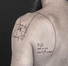 a man with a tattoo on his back has a geometric design and is looking at the sky