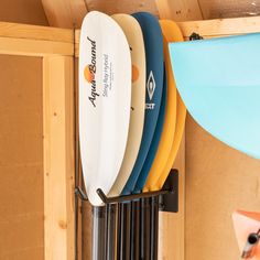 several surfboards are hanging on the wall