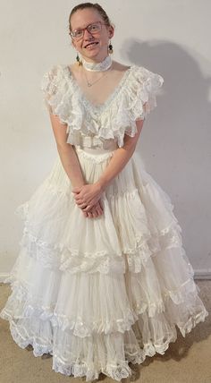 This was my mother's wedding dress when she married my father in 1984.  It's "virgin white" and very frothy and cupcakey.  It is meant to have a hoop skirt underneath, hence the layers. My model is 5'4" barefoot.  She is a size 4. Also comes with a halo headpiece with trailing veil. Please feel free to message me with any questions! Gender Neutral Wedding Attire, Ugly Wedding Dress Funny, Oaxaca Wedding Dress, Old Wedding Dresses Vintage, Puffy Dress Aesthetic, Fat Wedding Dress, Repurposed Wedding Dress Ideas, Bad Wedding Dresses, Southern Belle Wedding Dress