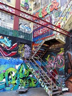 graffiti on the side of a building with stairs