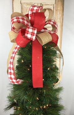 a christmas tree with a red and white bow