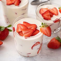 two glasses filled with yogurt and strawberries