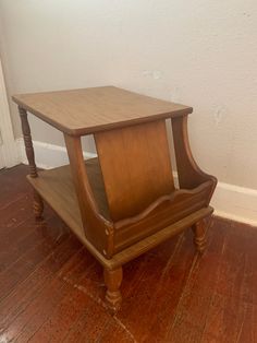 a wooden table sitting on top of a hard wood floor