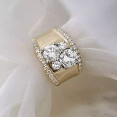 three stone diamond ring on white fabric