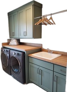 a washer and dryer sitting next to each other in a room with cabinets