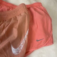 2 Pairs Of Nike Shorts Size Small. Coral Shorts Were Used Once And Washed The Mauve Color Shorts Are Brand New Without Tags Nike Athletic Shorts For Beach In Spring, Nike Summer Shorts, Nike Summer Workout Shorts, Nike Orange Short Bottoms, Nike Orange Shorts, Nike Orange Bottoms For Spring, Nike Orange Shorts For Spring, Nike Orange Workout Bottoms, Coral Shorts