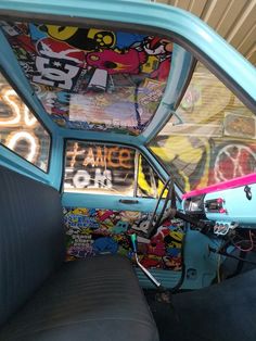 the interior of an old car with graffiti all over it