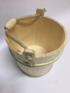 an empty wooden basket with rope handles