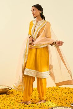 Glaze mustard kurta with gota patti work and highlighted with basra moti. Paired with salwar and rose pink dupatta.
Component: 3
Pattern: Embroidered
Type Of Work: Gota and Bead Work
Neckline: Mandarin
Sleeve Type: Long Sleeves
Fabric: Kurta - Silk Chanderi; Salwar - Bamberg Satin; Dupatta - Silk Organza
Color: Yellow
Other Details: 
Gota and bead work
Embroidered dupatta
Occasion: Wedding,Mehendi - Aza Fashions Gota Patti Embroidery, Yellow Kurta, Indian Fashion Designers, Pernia Pop Up Shop, Silk Organza, Kurta Set, Set For Women, Mandarin Collar, Festival Wear