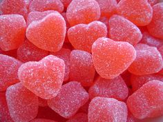 a bowl filled with pink and orange heart shaped candies