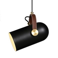 a black and brown light hanging from a ceiling fixture with a leather strap around it's neck