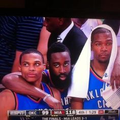 two basketball players are posing for a photo on the tv screen with their arms around each other