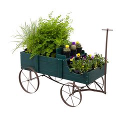 a green wagon filled with lots of plants