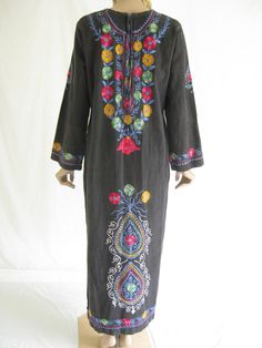 "Beautiful vintage 70s embroidered boho festival maxi dress. Soft, 100% cotton fabric. Amazing, vibrant embroidery on black background. Cool and comfortable. Full sleeves. Metal zipper in back. Made in Pakistan. In excellent vintage condition. Size: medium Bust: 44\" Waist: 40\" Hips: 46\" Length: 54\"" Long Folk Style Embroidered Dress, Cotton Embroidered Dress With Resham Embroidery For Festival, Black Cotton Folk Embroidered Dress, Black Cotton Dresses With Chikankari Embroidery, Bohemian Black Maxi Dress With Floral Embroidery, Embroidered Folk Style Long Maxi Dress, Folk Style Embroidered Maxi Dress For Festival, Folk Style Embroidered Long Maxi Dress, Folk Embroidered Long Maxi Dress