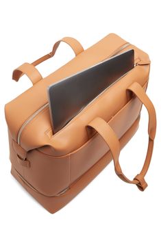 a tan leather briefcase with an electronic tablet in the pocket and strap around the handle