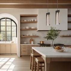 a large kitchen with wooden cabinets and white counter tops, along with an arched window