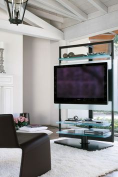 a living room with a large flat screen tv mounted to the side of a wall