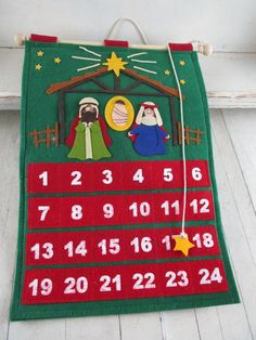 a felt nativity calendar hanging on a wall