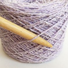 a ball of yarn with a wooden needle