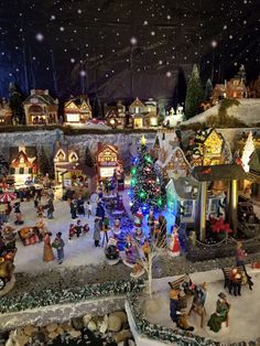 a christmas village with lots of lights and decorations