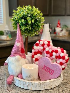 a table topped with a vase filled with flowers and other decorations next to a candle