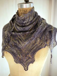 a mannequin wearing a purple shawl