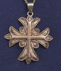 "Presented here is Solid 18K Filigree Cross Pendant which dates from the last days of the 19th century The cross pendant is hallmarked with the Owl which is the French Hallmark for certified 18 Carat Gold of mom French Origin. This very fine work is typical of Portugal and the Owl hallmark is the French guarantee for 18 Carat. It is rare to find such perfect filigree work in 18 K solid gold and in perfect and pristine condition It is a very fine and nice item to wear. It is a large item. Dimensi Traditional Medallion Jewelry With Historical Design, Gold Medallion Jewelry With Historical Design, Traditional Jewelry With Historical Design For Collectors, Bronze Intricate Pendant Jewelry, Bronze Pendant Jewelry With Intricate Design, Bronze Pendant With Intricate Design, Antique Gold Cross Pendant Necklace, Elegant Engraved Cross Pendant, Antique Handmade Cross Pendant Jewelry