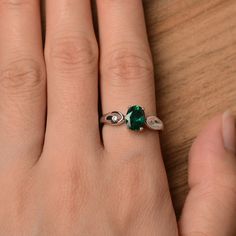 It is a lab emerald ring. The main stone is 6 mm*8 mm oval cut.weight about 1.13 carats. The basic metal is sterling silver and plated with rhodium. To change the metal to a solid gold (white/rose) or platinum is also available, please ask for a quotation if you want. You can also go to my shop Home for more elegant rings: https://www.etsy.com/shop/godjewelry?ref=hdr_shop_menu Emerald is the May birthstone. More emerald rings: https://www.etsy.com/shop/godjewelry?section_id=20709240 Customizatio Oval Emerald May Birthstone Ring, Oval Emerald Birthstone Ring For May, Green Oval Birthstone Ring For Anniversary, Oval Emerald Birthstone Ring In Silver, Oval Green Emerald Ring For May Birthstone, Silver Oval May Birthstone Ring, Oval Green Birthstone Ring With Prong Setting, May Birthstone Oval Silver Ring, Oval May Birthstone Ring For Promise