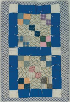 a blue and white quilt with squares on it