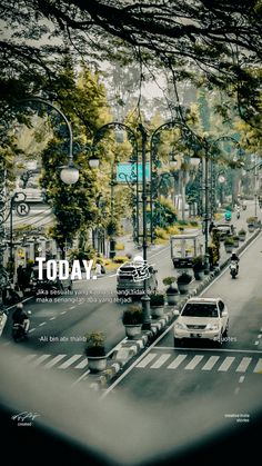 an image of cars driving down the road with trees on both sides and street lights above them